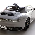 White Porsche Sports Car With Black Alloy Wheels And Sleek Front Design