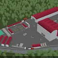 Industrial Factory Building With Red Roofs Surrounded by Green Trees and Open Space