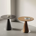 Round Black And Wooden Dining Tables With Coffee Cup And Magazines In Minimalist Interior