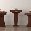 Three Wooden Podiums With Microphones And Flower Arrangements On Light Colored Wall And Wooden Floor