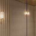 Modern Wall Sconces With Glass Shades On Textured Wall And Warm Lighting Glow