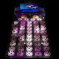 Banquet Hall With Stage Large Screen Floral Pattern Purple White Chairs And Crowd
