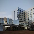 Modern Multi Story Office Building With Large Windows Surrounded By Trees Greenery And Lawns