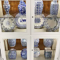 White Display Bookcase With Glass Doors Holding Blue And White Vases Books And Decorations