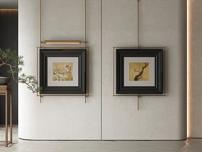 Abstract Paintings Hanging On Light Colored Wall With Black Frames Alongside Table And Green Plant 3d model