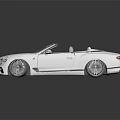 White Luxury Convertible Car With Sleek Design And Open Top Front Grille And Alloy Wheels