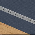 White Power Strip With Multiple Outlets On Blue Fabric And Wooden Surface