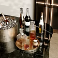 Wine Bottles and Glasses with Ice Bucket on Gold Tray Modern Black Marble Countertop