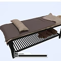 Comfortable Massage Bed With Dark Mat and Pillows Underbed Striped Rack and Brown Towels