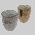 Golden Metallic Vase With Curved Design And Small Decorative Metal Object