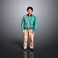 Man in Green Jacket and Beige Pants Standing with Headphones on Gray Background