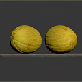 Two fresh yellow melons placed on a natural wooden cutting board