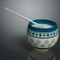 Carved Sculpture Bowl With Blue White Geometric Leaf Patterns And Silver Spoon On Smooth Surface