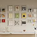 Colorful Wall Art Display with Various Prints on Beige Wall and Light Wooden Table