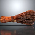 Handmade Brown Broom With Woven Handle And Natural Bristles On Gray Smooth Surface With Reflection