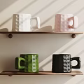 Colorful Ceramic Mugs in White Pink Green Black on Two Wooden Shelves