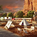 Scenic Camping Site Featuring Multiple Tents Trees String Lights Tables Chairs And Mountain View