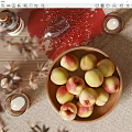 Fresh Peaches in Ceramic Bowl on Rustic Wooden Table with Candles and Wine Glass