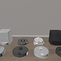 Different Colors And Styles Of Robotic Vacuum Cleaners As Daily Household Appliances On Wooden Floor