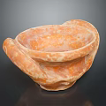 Textured Orange Bowl Shaped Sculpture Carving With Curved Edges And Dark Background