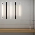 Modern Sleek Black Linear Pendant Lights In White Wall Interior With Wooden Shelf