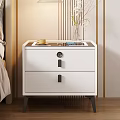 Modern White Nightstand With Drawers Black Handles Yellow Cup Blue Book And Vase In Bedroom