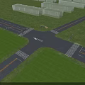 Road Infrastructure Featuring Multi Lane Intersection With Streetlights Green Grass Verges And Vehicles Driving