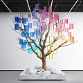 Colorful Square Tree Art Installation With Brown Trunk And White Stones