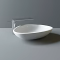 White Oval Countertop Wash Basin With Modern Silver Faucet And Sleek Design