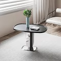 Modern Black Oval Top Side Table With Metal Base Blue Vase Green Plant And Open Book