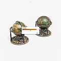 Decorative Vintage Globes on Ornate Metal Stands with Intricate Base Patterns