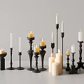 Decorative Candle Lamps With Various Black Holders And White Lit Unlit Candles