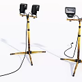 Portable Spotlights With Yellow Black Tripod Stands And Power Cords
