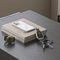 Modern Decorative Ornament Set with Mobile Phone on Stacked Books Watch Keys on Table