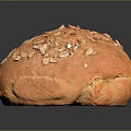 Freshly Baked Golden Round Bread Topped With Crunchy Oat Flakes And Soft Texture