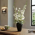 White Flowers In Black Vase On Wooden Table With Coffee Cup And Sunglasses Near Window