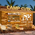 Wooden Cabin Cafe with Thatched Roof Palm Trees and Outdoor Seating at Camp Cutk