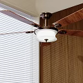 Ceiling Fan With Light Installed On Ceiling By Window Blinds And Wooden Walls