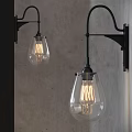Vintage Black Metal Wall Sconces With Clear Glass Shades And Filament Bulbs On Gray Wall
