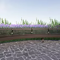 Curved Metal Landscape Bench With Striped Seat Purple Flowers And Stone Pavement