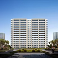 Modern High rise Residential Building Exterior With Green Lawns Trees And Clear Blue Sky