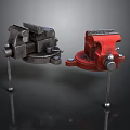Two Black and Red Metal Bench Vices With Fixed Base Adjustable Jaws On Reflective Surface