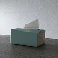 Light Green Household Tissue Box With Pulled Out Paper On Wooden Tabletop
