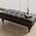 Black Leather Tufted Bench With Decorative Legs And Books On Top With Window Blinds