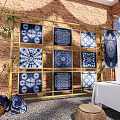 Maybach Display Area Featuring Blue White Striped Canopies Brick Walls Long Table And Stone Stools