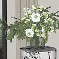 White and Green Flowers in Glass Vase on White Black Pattern Round Table with Leaves