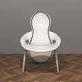 Modern Dining Chair With Woven Design And Dark Frame On Herringbone Wooden Floor