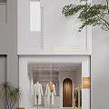 Fashion Clothing Storefront With White Facade Mannequins And Golden Door Signage