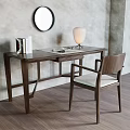 Walnut Desk With Books Glasses Table Lamp And Chair On Gray Wall With Round Mirror