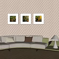 Modern Sectional Sofa With Beige Cushions And Three Framed Artworks On Quilted Wall